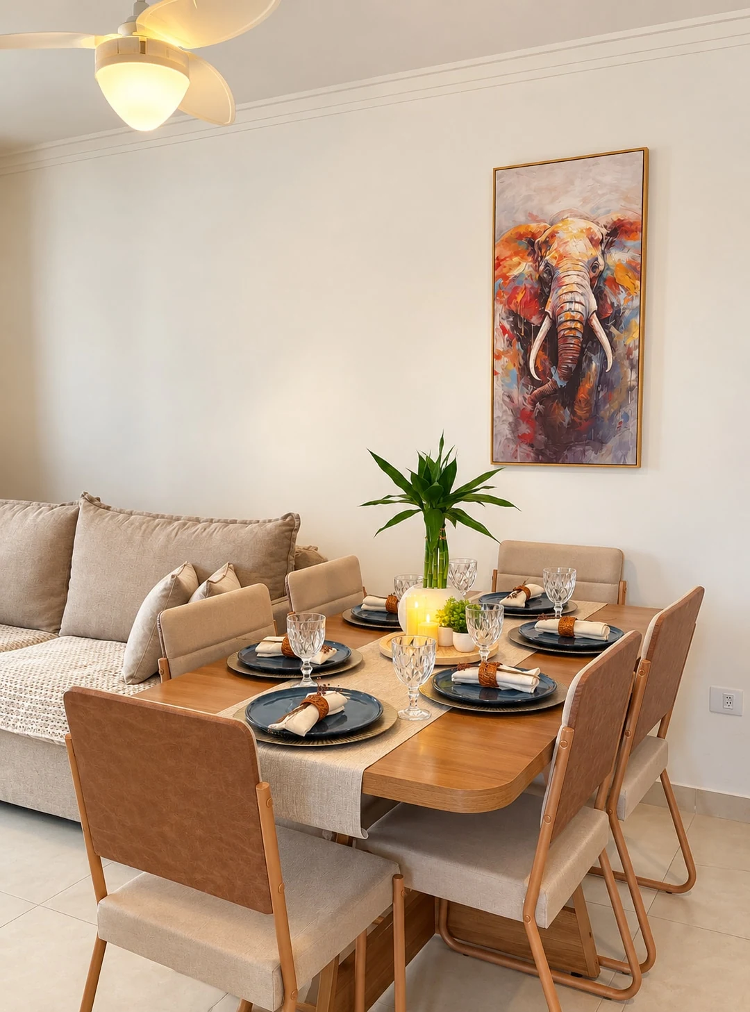 Living and dining room with sofa bed and a table set for six