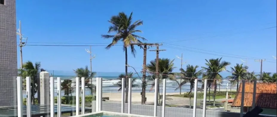 Beach and palm trees, beachfront apartment in Praia Grande